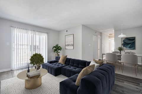 A living room with a dark blue sofa and a coffee table.