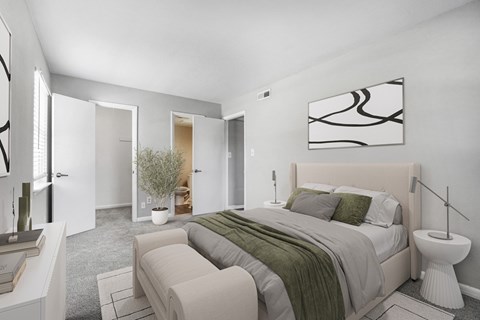 A bedroom with a large bed and a painting on the wall.