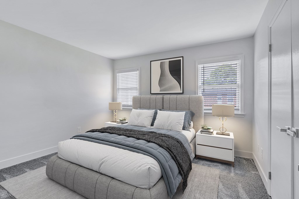 A bedroom with a large bed and a painting above it.