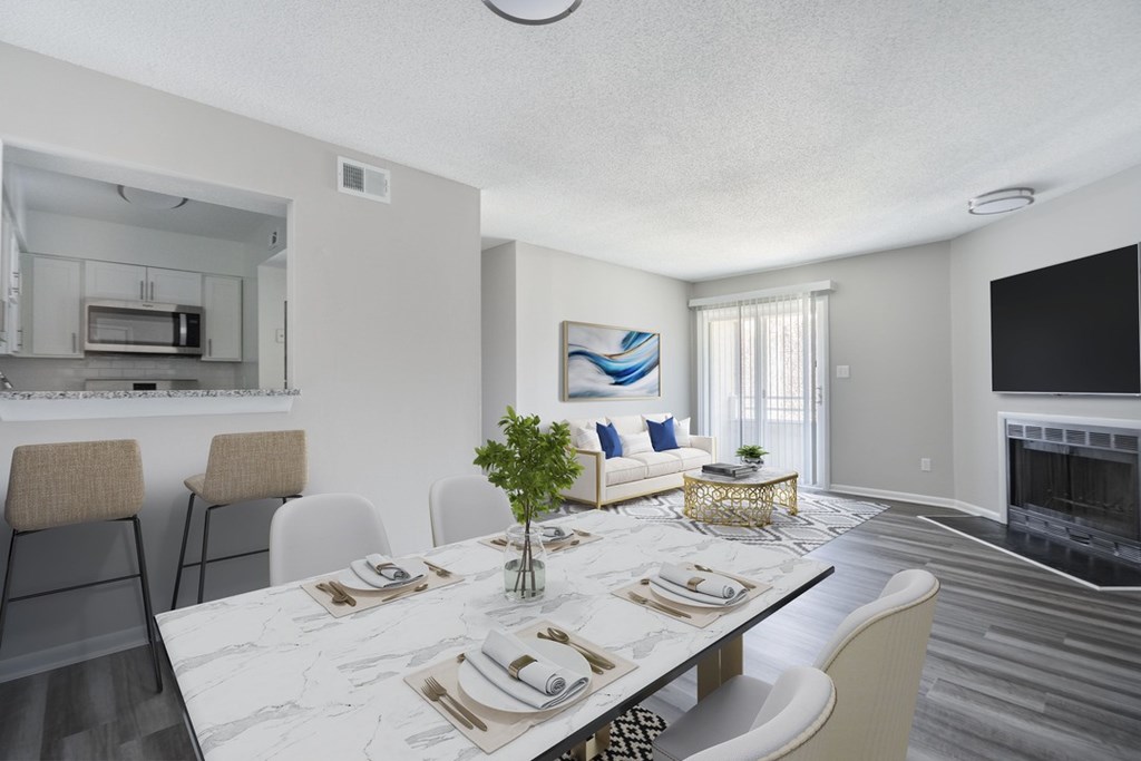 A modern dining room with a marble table and chairs.