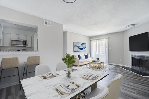 A modern dining room with a marble table and chairs.