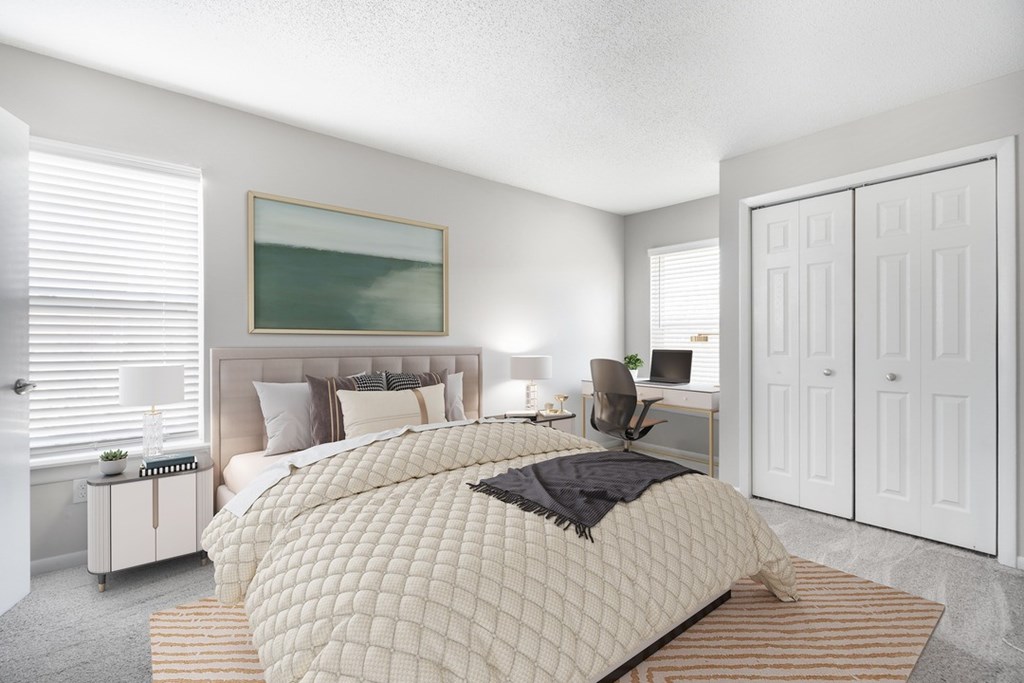 A bedroom with a large bed and a painting on the wall.