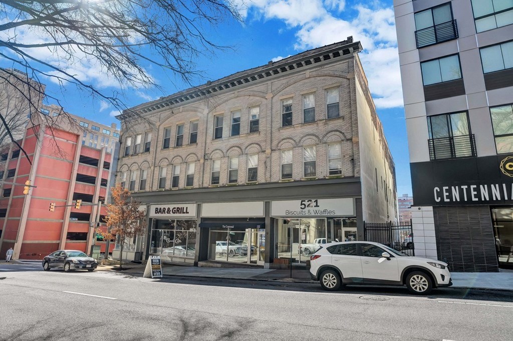 a building on a city street with a car parked in front of it
