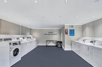 A laundromat with the sign "Alexa Fold the Laundry" on the wall.