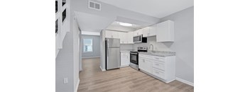 A kitchen with white cabinets and stainless steel appliances.