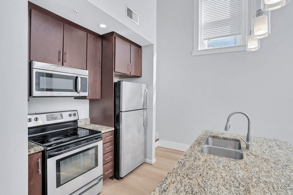 a kitchen with granite counter tops and stainless steel appliances