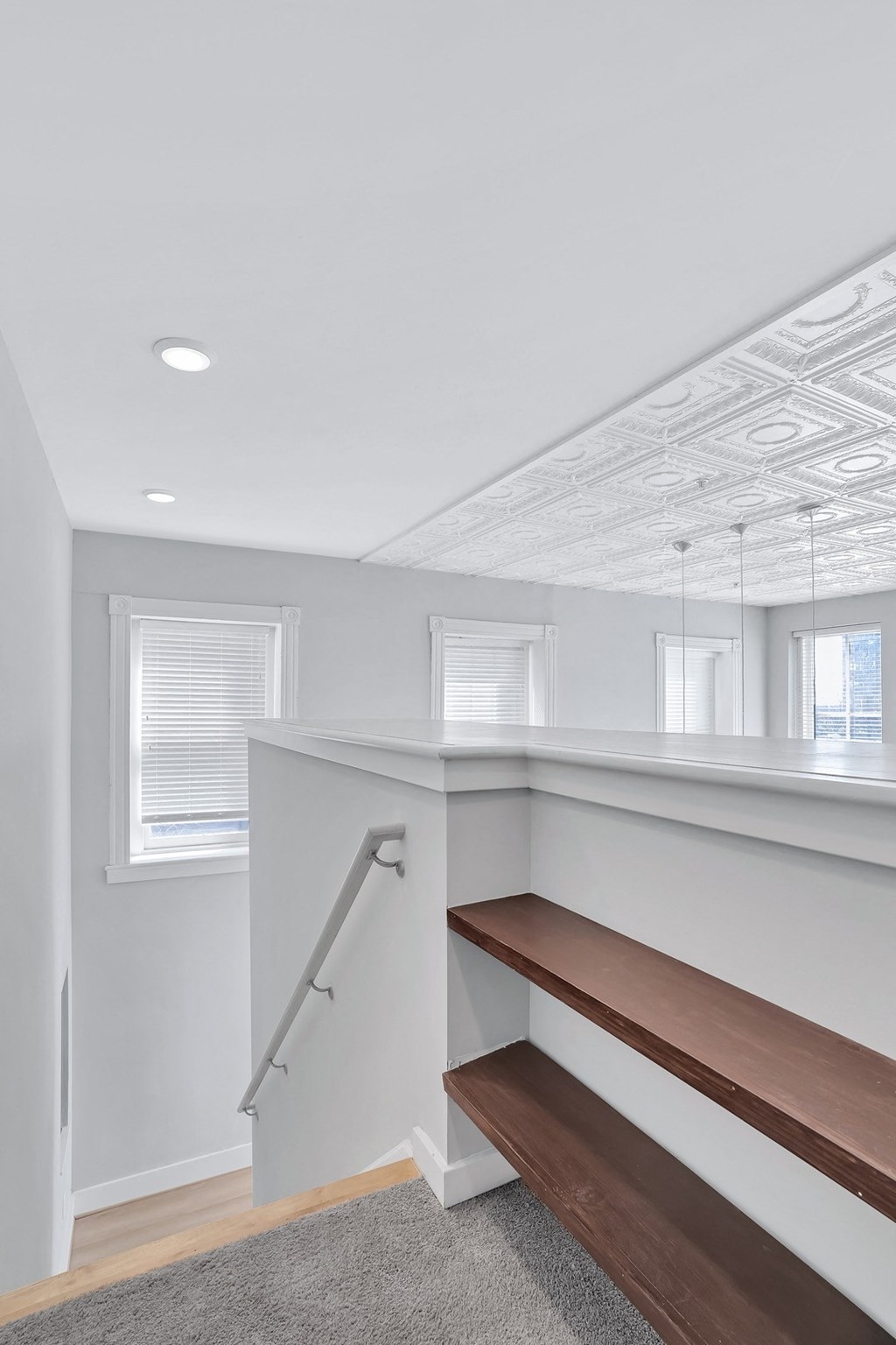 a view of a staircase in a home with white walls and wood floors