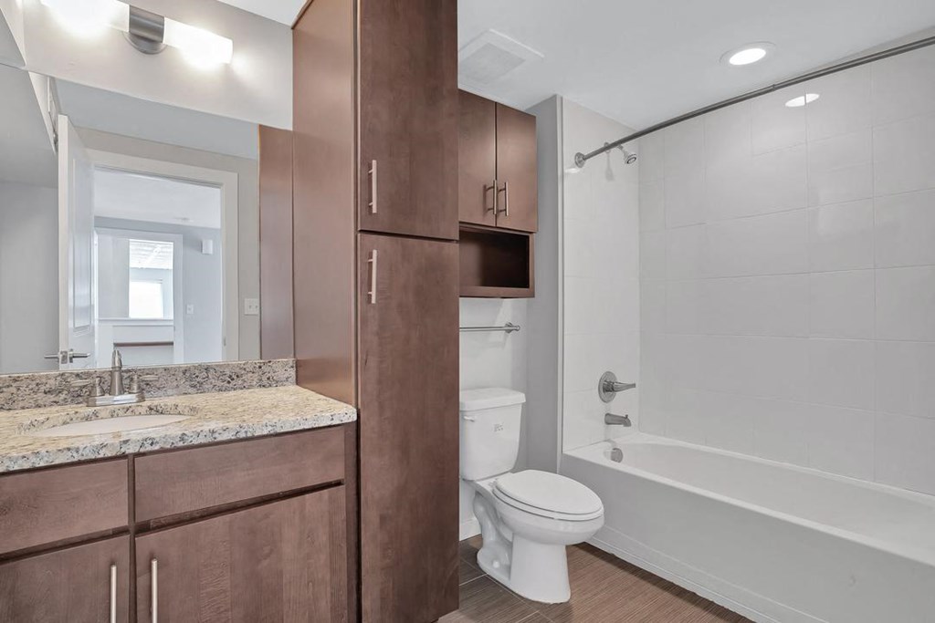 a bathroom with a toilet and a shower and a sink