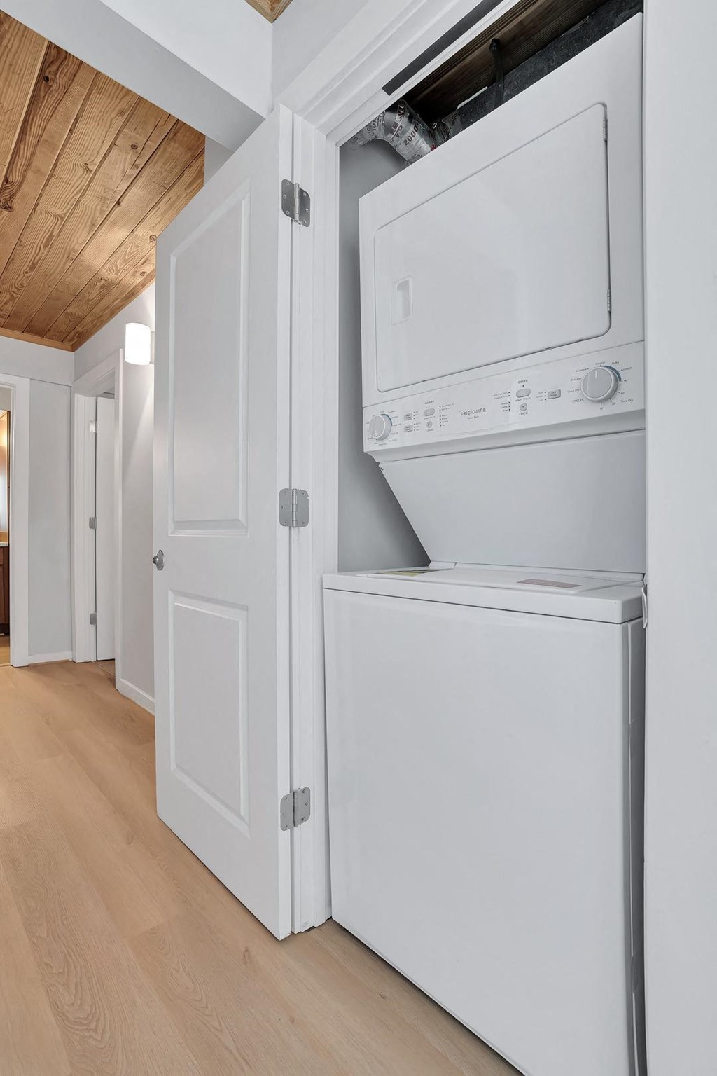 a white washer and dryer in a room next to a door