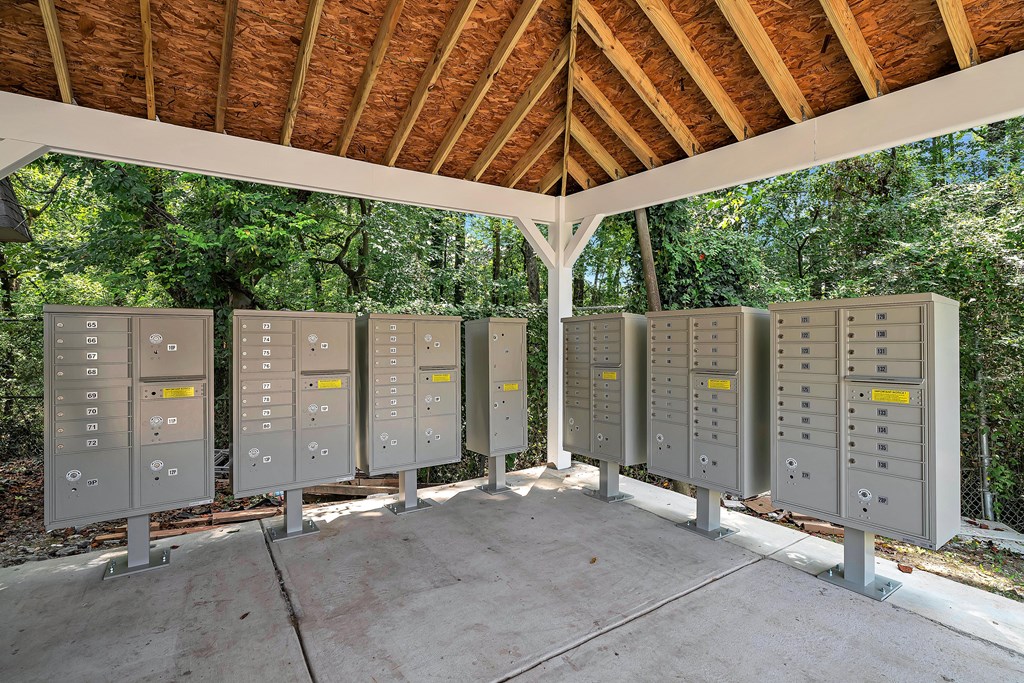 A row of electrical boxes are lined up in a pavilion.
