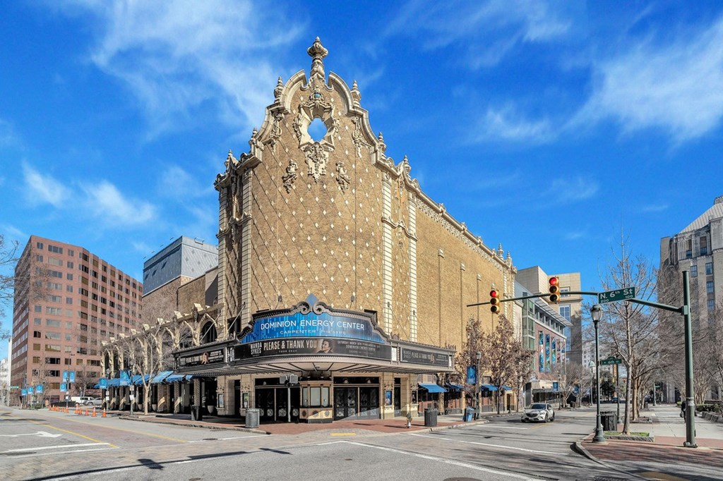 an old theater on the corner of a city street