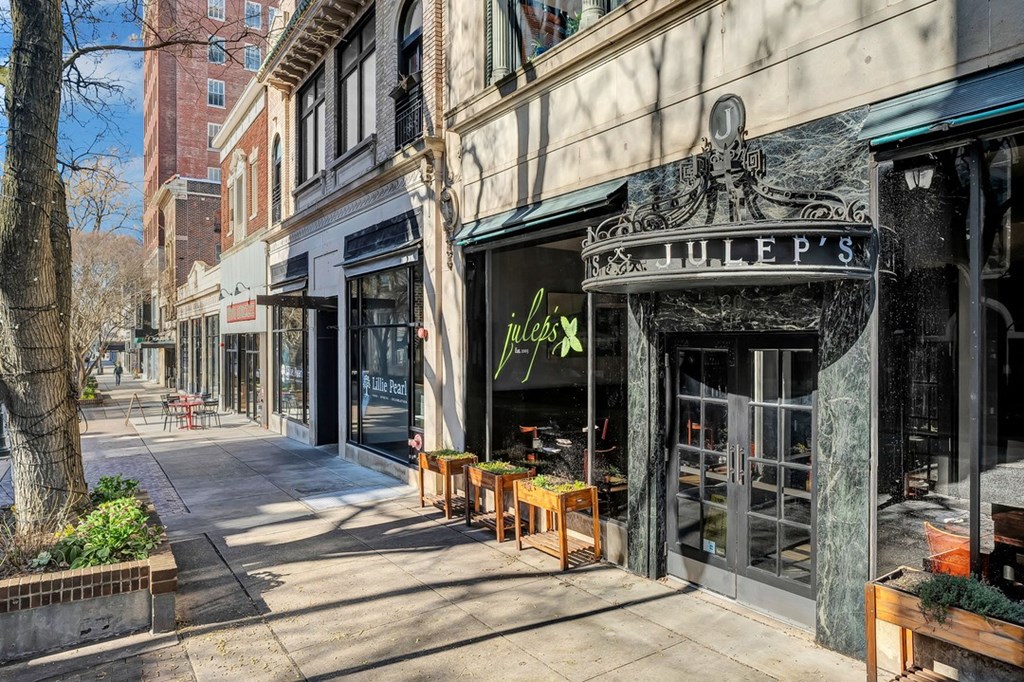 a city street with shops and a sidewalk