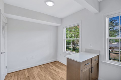 A room with a window and a cabinet.