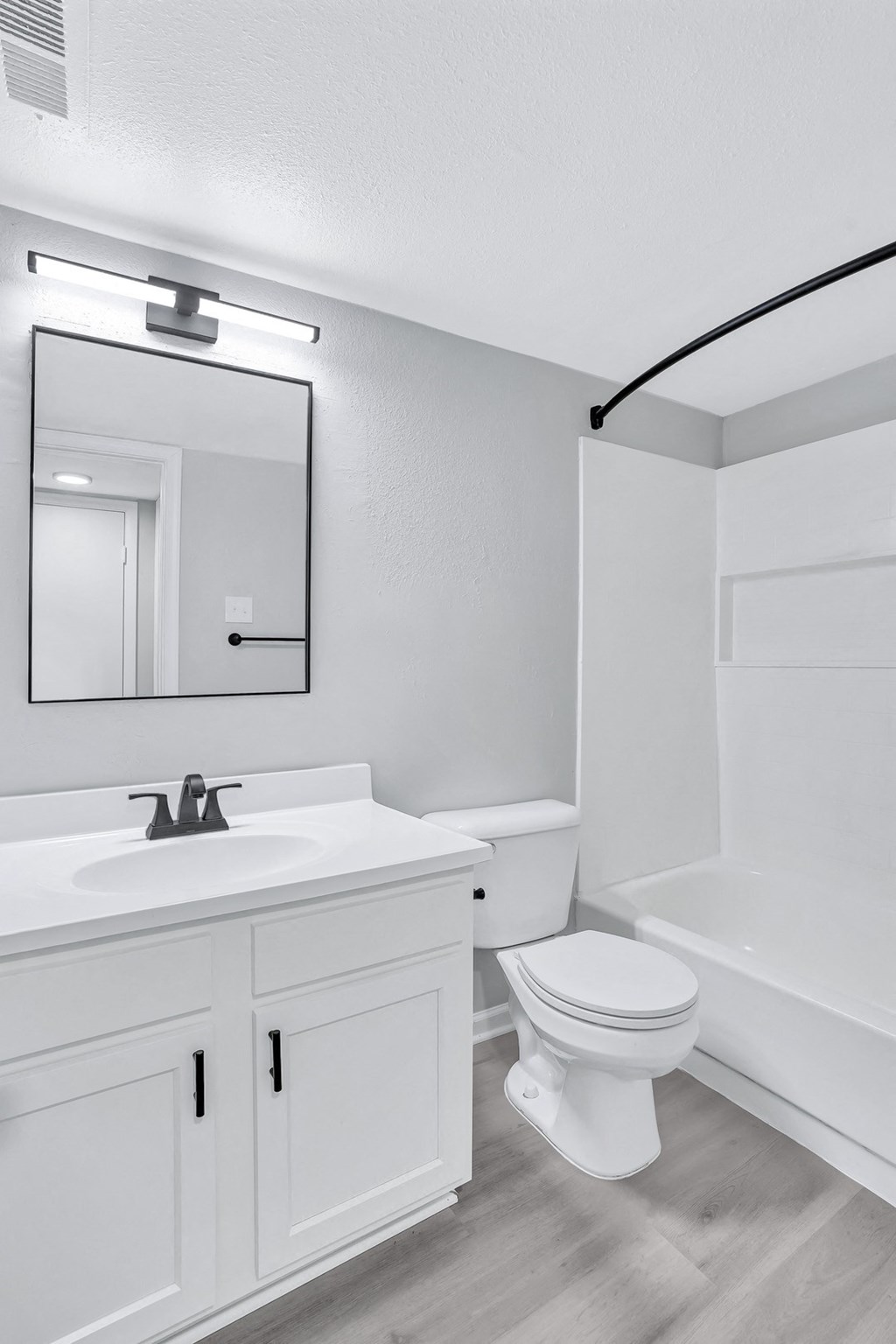 a bathroom with a sink toilet and a mirror