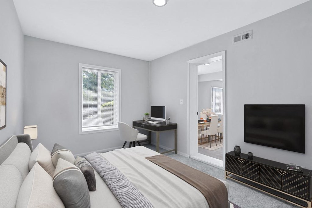 a bedroom with a bed and a tv