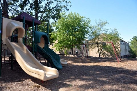 a playground with slides and a swing set