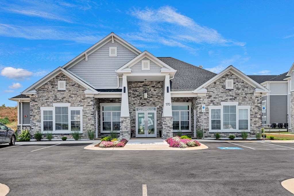 a large house with a parking lot in front of it