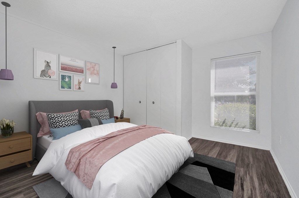 a bedroom with white walls and a large window