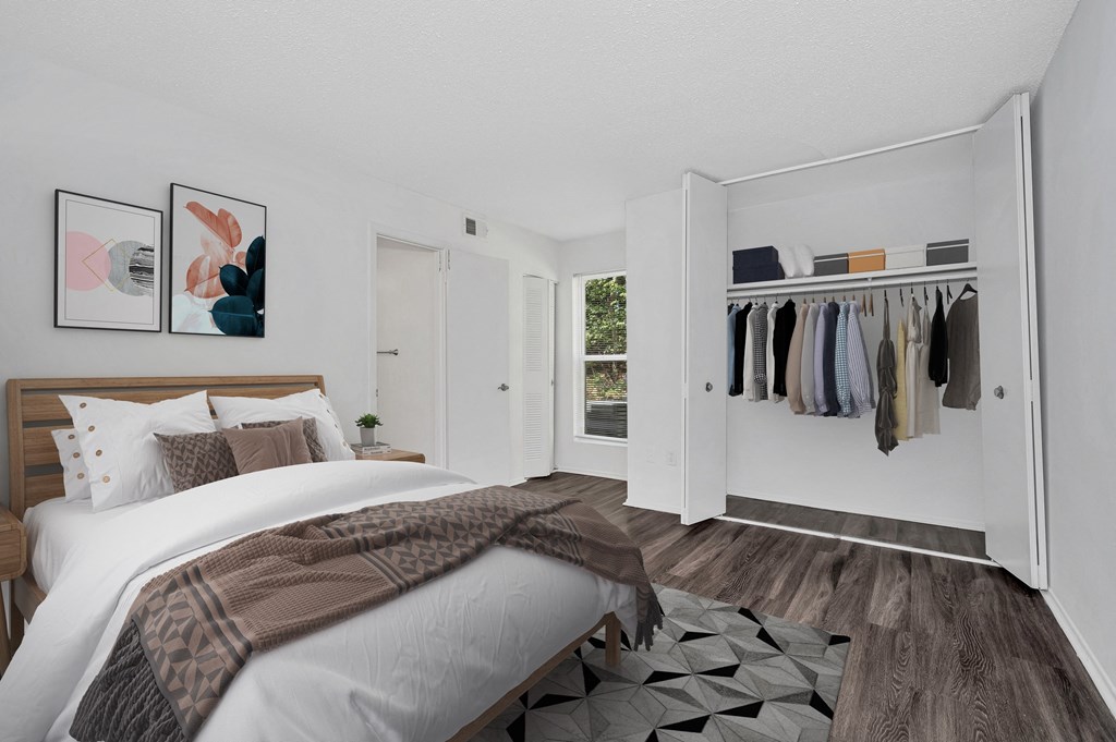 a bedroom with a large bed and a closet with a sliding door