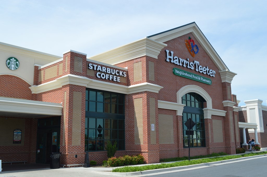 a brick starbucks coffee building on the side of a street