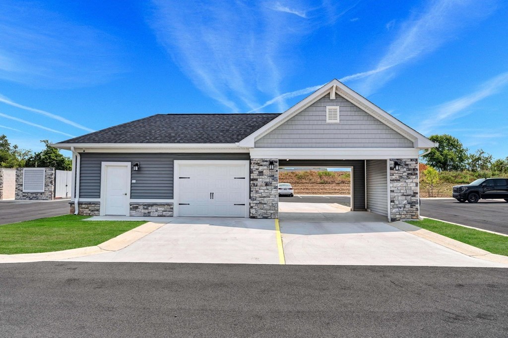the front of a house with a driveway and a garage door