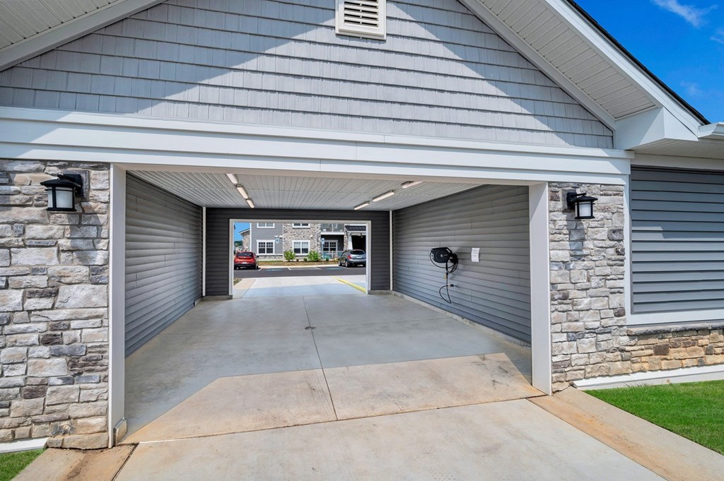 the drive way of a house with a concrete driveway