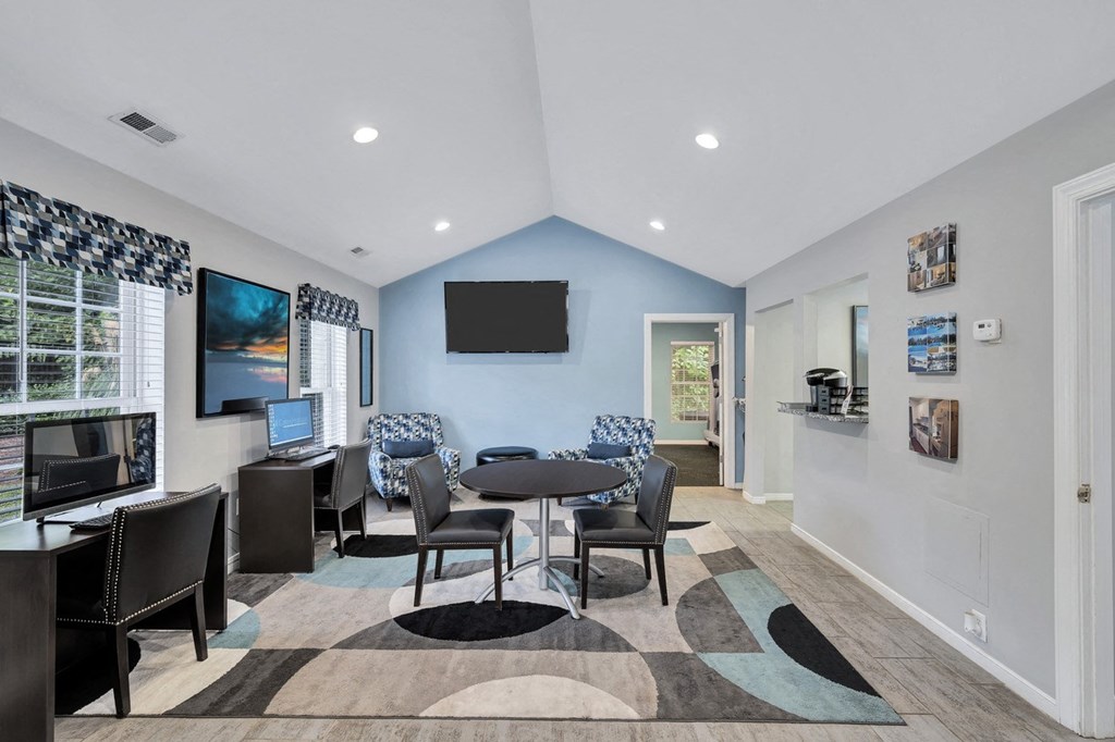 a living room with a table and chairs and a television
