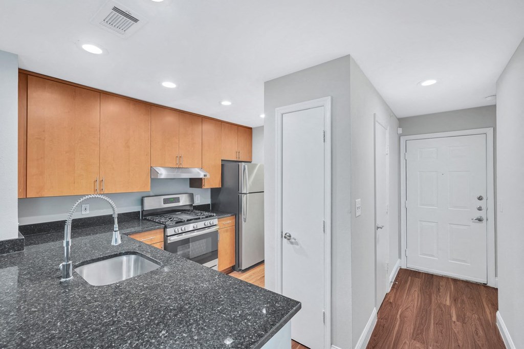 a kitchen with a granite counter top and a sink