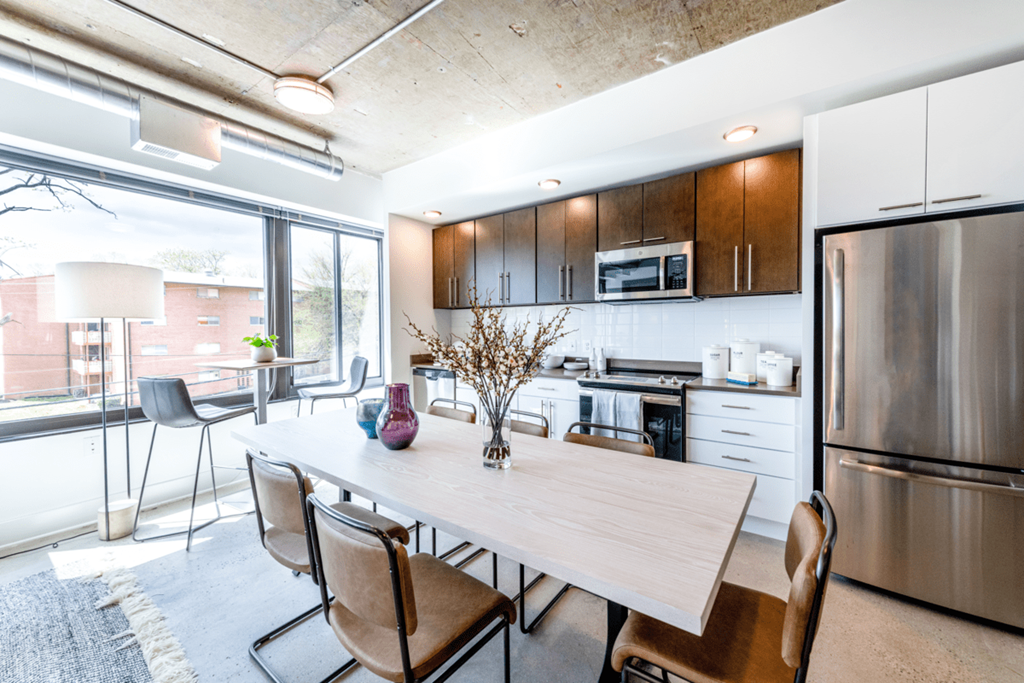 Kitchen and dining area with table and chairs.