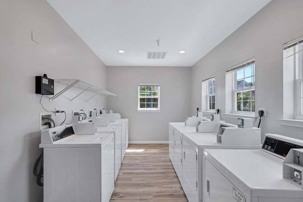 a laundry room with washers and dryers