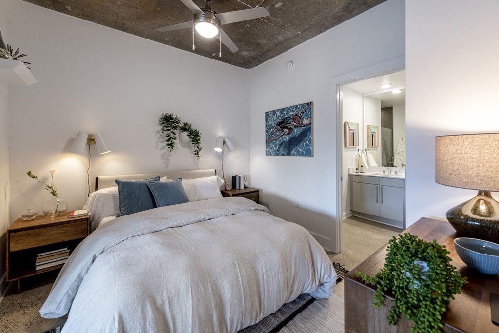 a bedroom with a bed and a ceiling fan