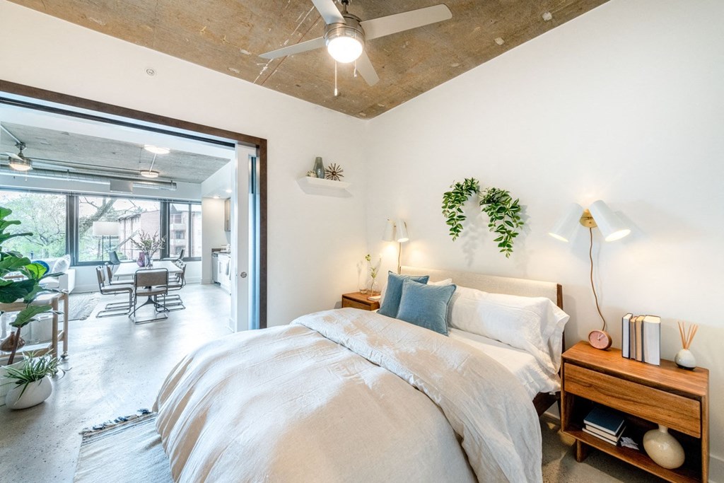a bedroom with a bed and a ceiling fan