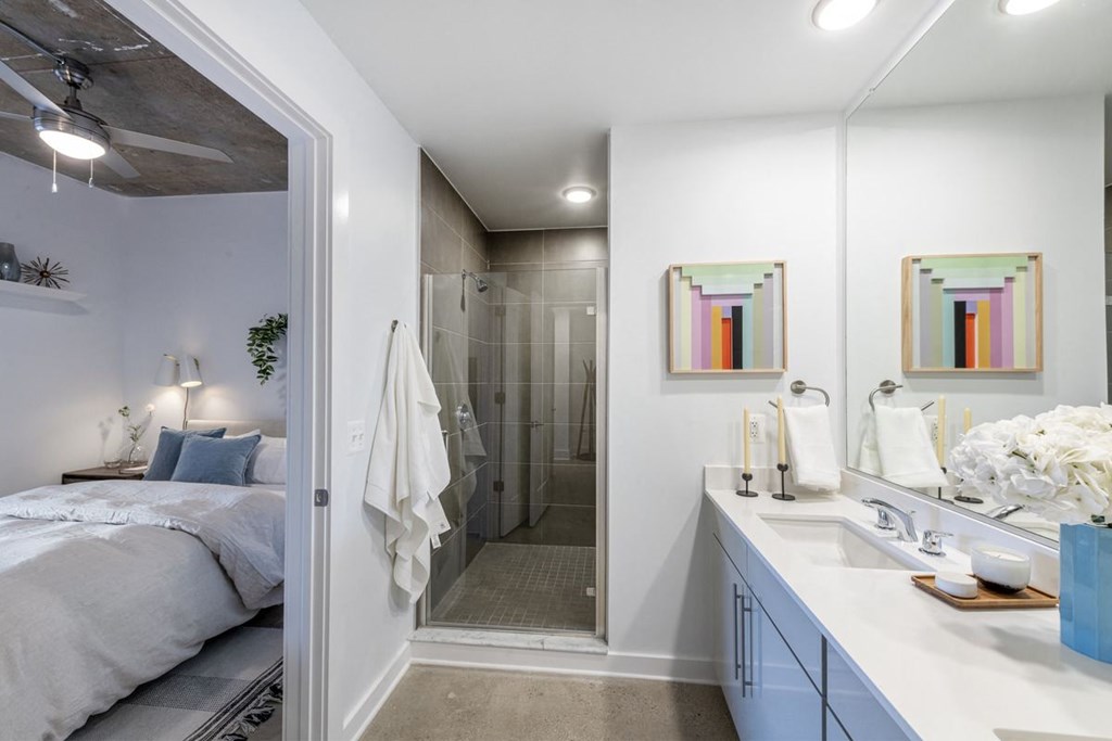 a bathroom with a shower and a bed