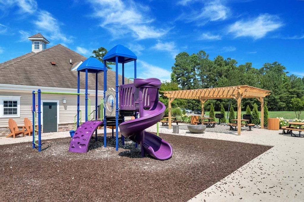 a purple playground with a purple slide in front of a house