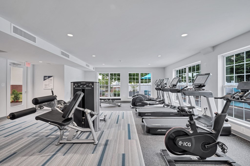 a gym with treadmills and other exercise equipment