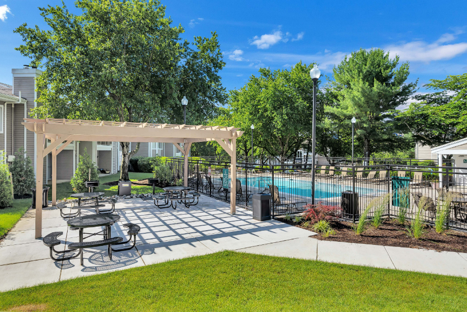 our apartments have a pool and a patio with tables and chairs