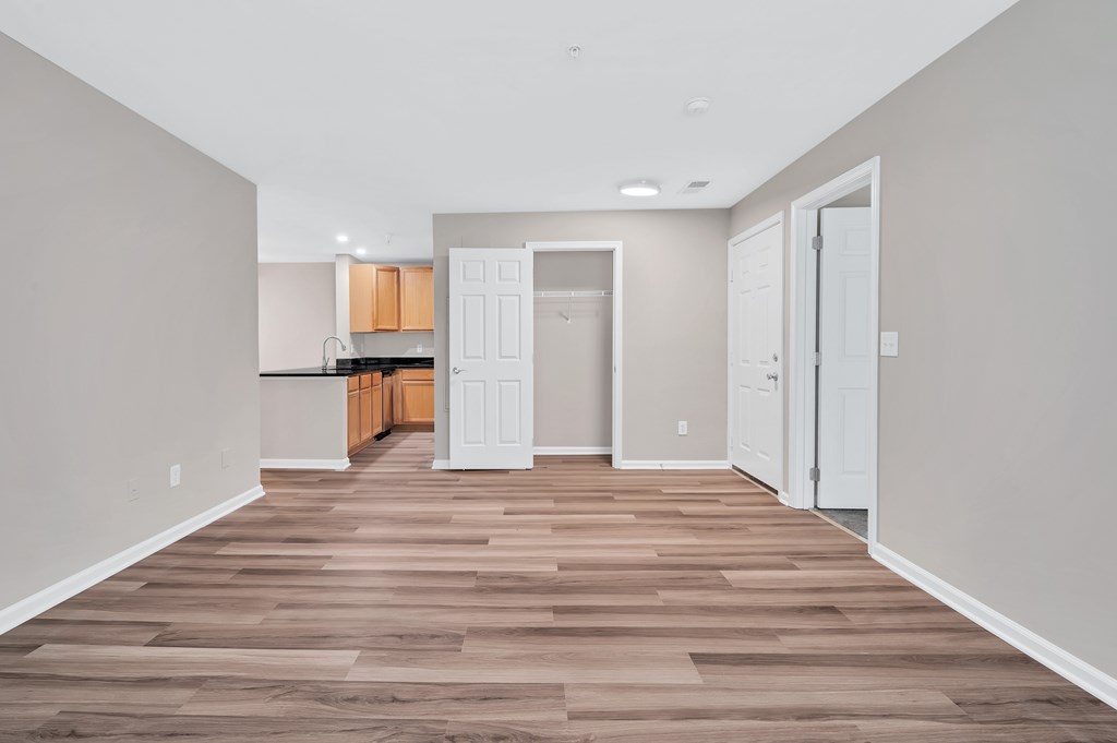 A room with wooden flooring and white walls.
