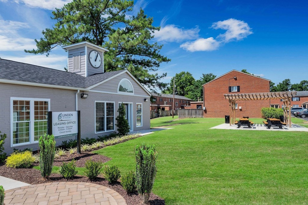 the preserve at ballantyne commons exterior with a lawn and clock tower