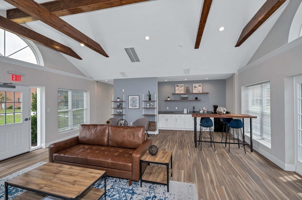 a living room with a couch and a table and a kitchen