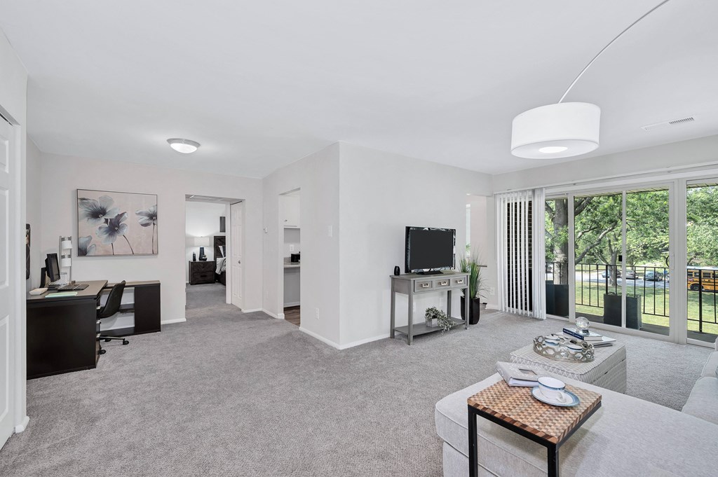 a living room with white walls and carpet