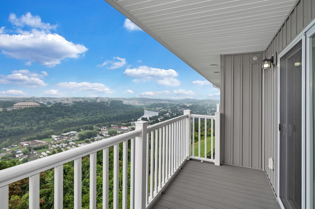a balcony with a view of a city and a river