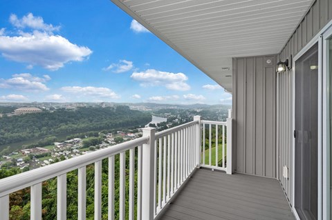 a balcony with a view of a city and a river