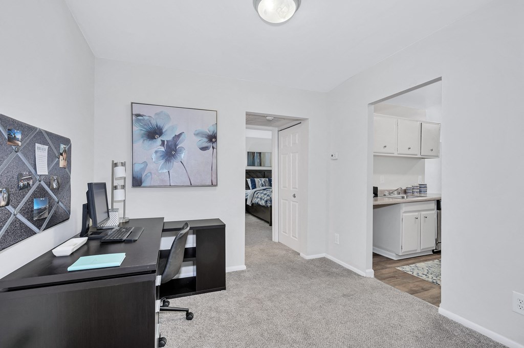 a bedroom with a desk and a closet in a house
