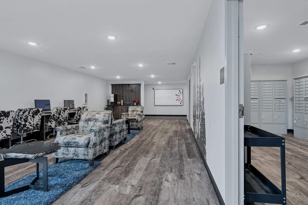 a living room with couches and chairs and a desk
