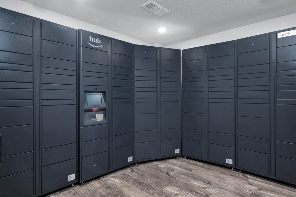 a row of dark blue lockers in a room with wood floors