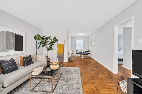 A living room with a grey couch and a coffee table.