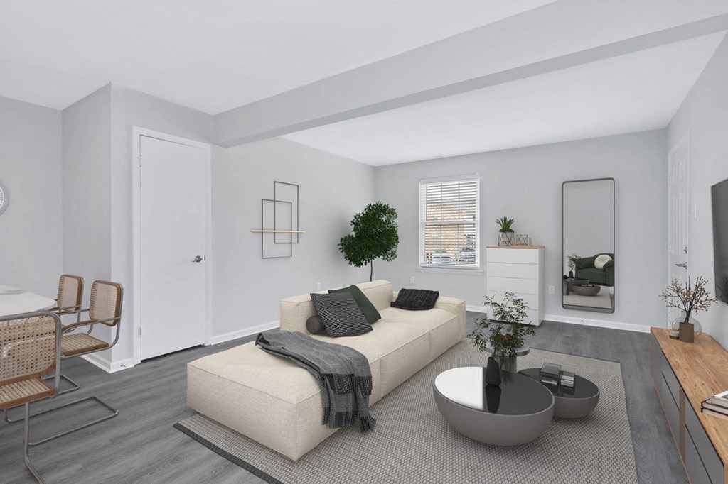 a living room with grey walls and a beige couch