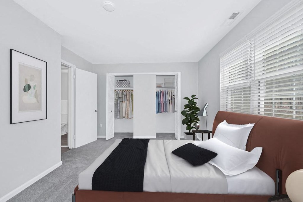 a bedroom with a large bed and a large window