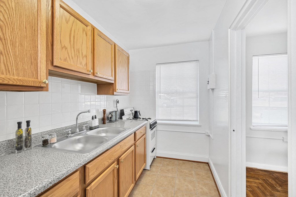a kitchen with wooden cabinets and a sink and a window