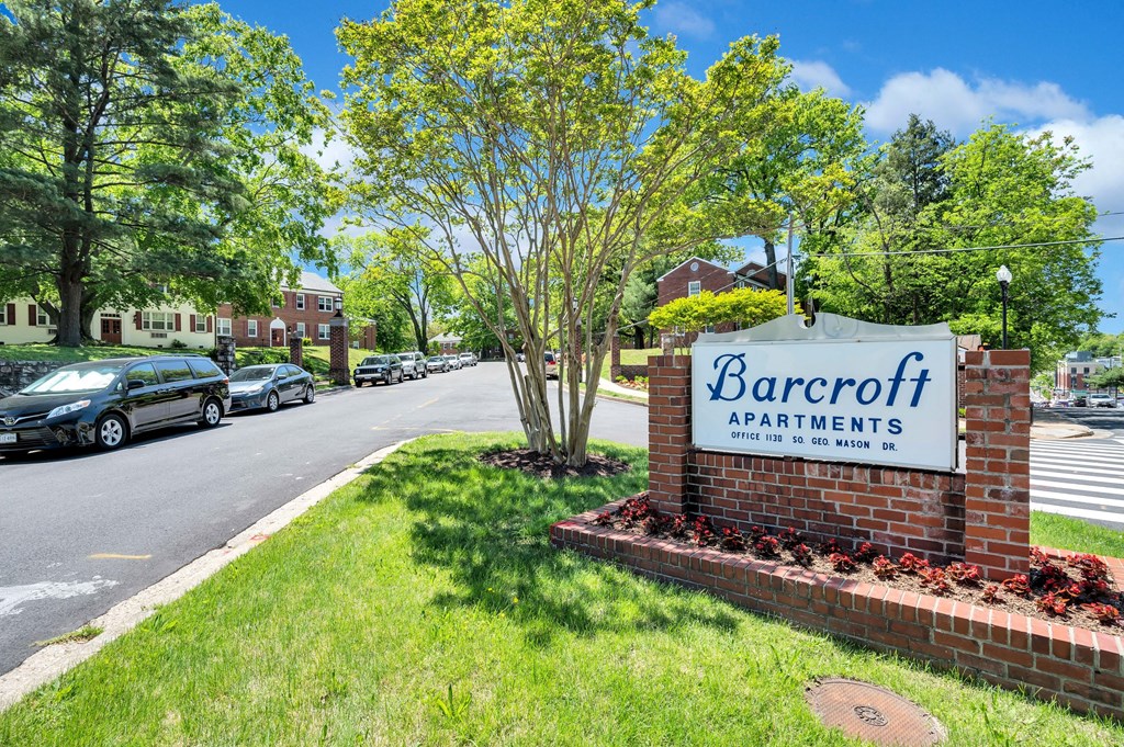 a sign for barcroft apartments on the side of a street